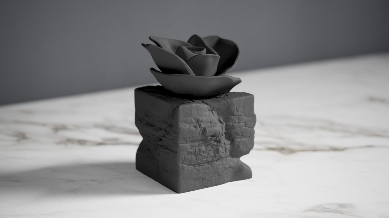 Eternal Bloom black rose sculpture styled on a dark wooden desk beside books