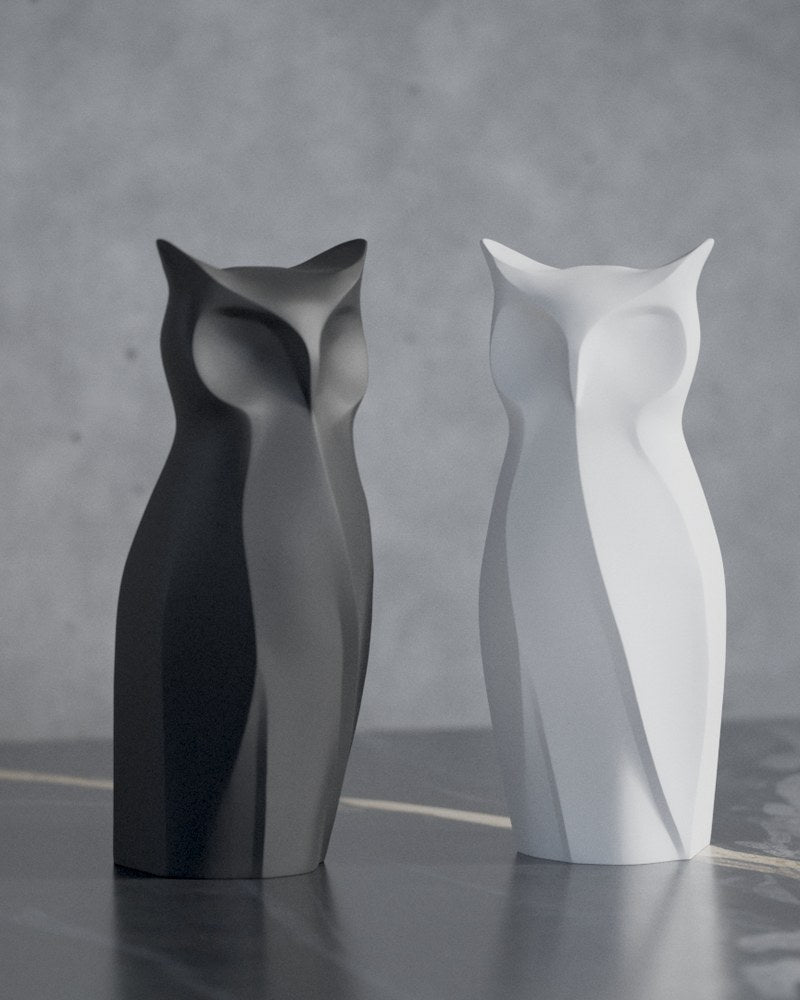Nocturna geometric owl sculpture in close-up, sharp faceted surface detail against neutral background