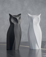Nocturna geometric owl sculpture in close-up, sharp faceted surface detail against neutral background