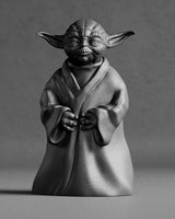 Close-up of a detailed Master Yoda sculpture with flowing robe folds and calm facial expression