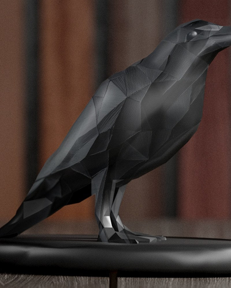 Low poly crow sculpture in dark geometric form, close-up on faceted surface detail