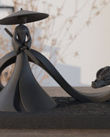 Close-up of black samurai dragon sculpture showing warrior figure with katana and serpentine dragon detail