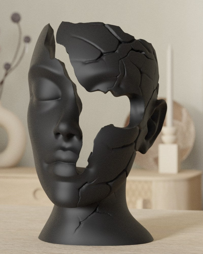 Close-up of minimalist face sculpture with fractured contours against a neutral background