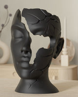 Close-up of minimalist face sculpture with fractured contours against a neutral background