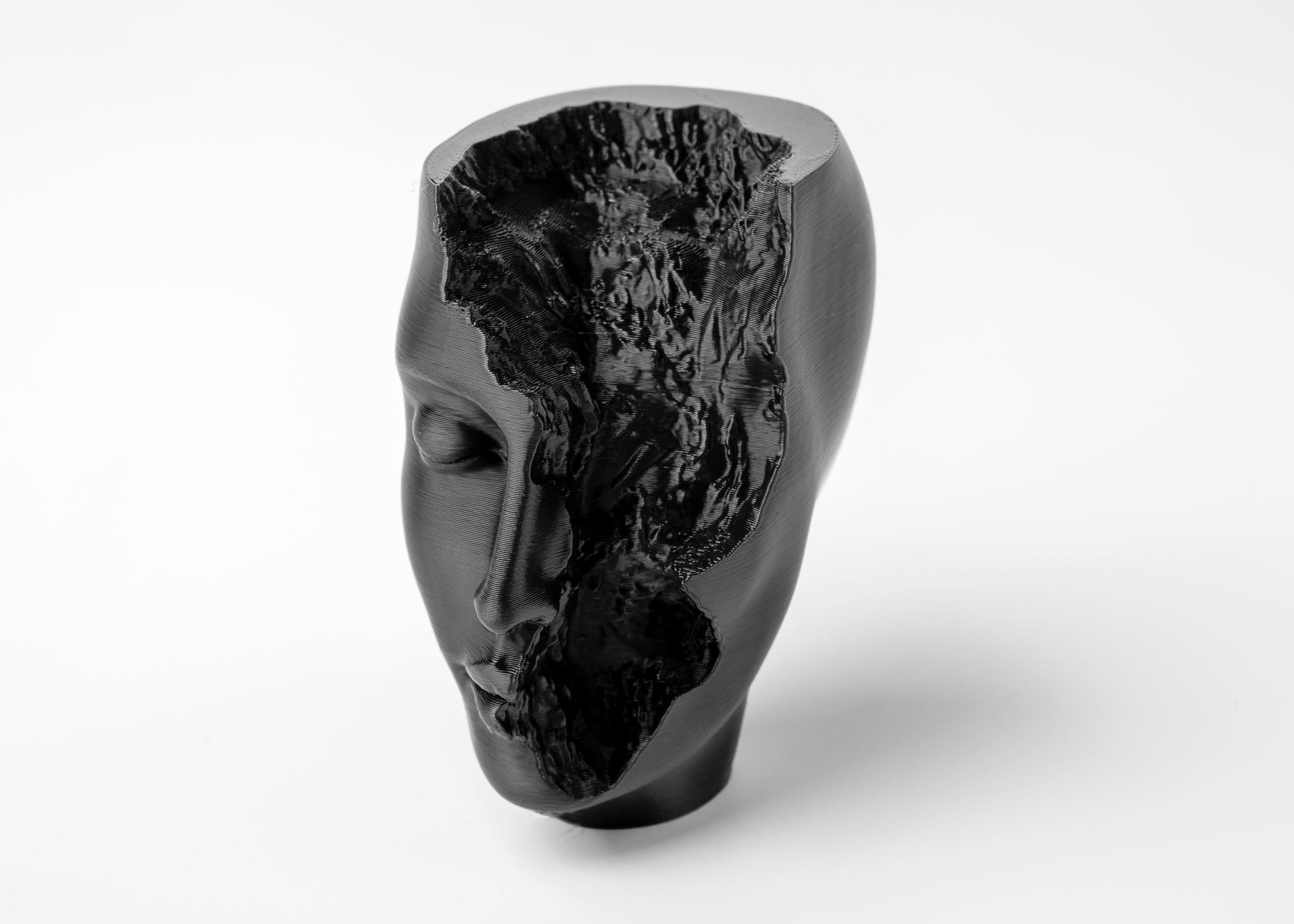 Abstract face sculpture styled on a minimalist shelf with neutral decor and soft natural light