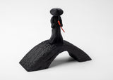 Samurai sculpture styled on a wooden desk with small ceramic and natural objects