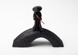Close-up of samurai figure detail — flowing robe and conical hat in muted finish