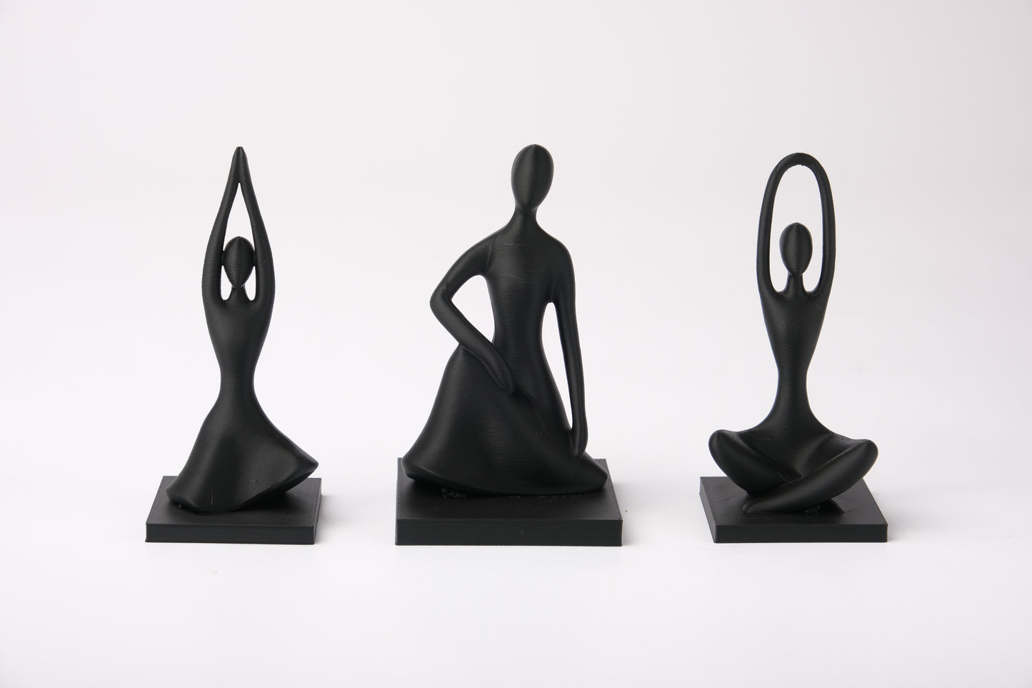 Harmony Pose Trio styled on a wooden shelf beside a small plant and ceramic bowl