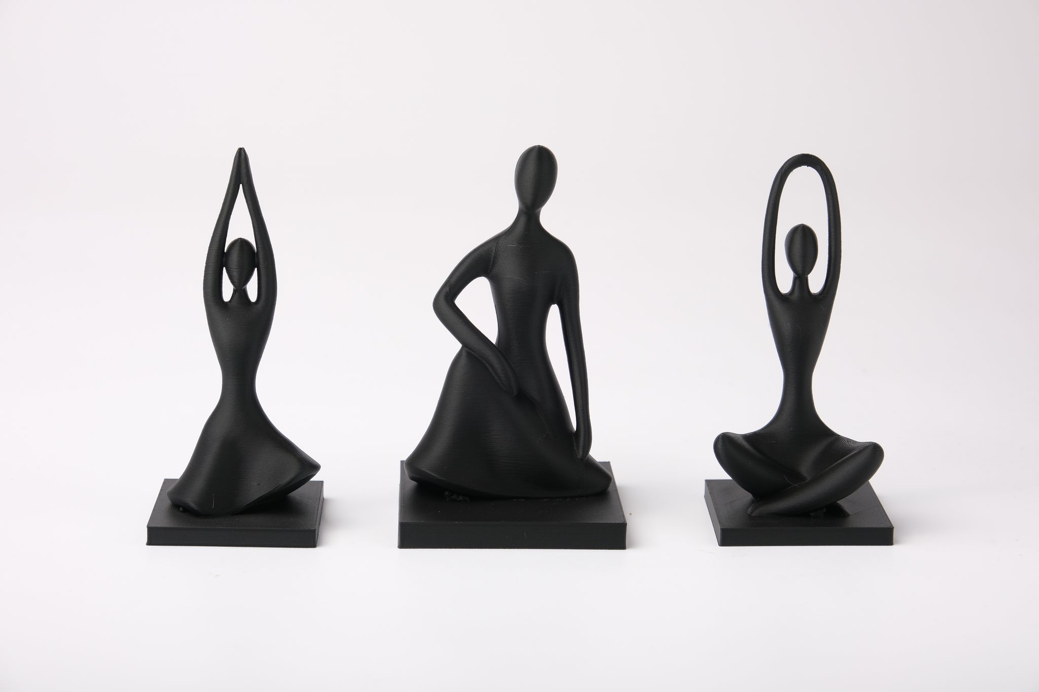 Harmony Pose Trio styled on a wooden shelf beside a small plant and ceramic bowl