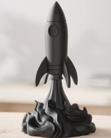 Close-up of a futuristic rocket sculpture rising from a swirling smoke base, in neutral tones