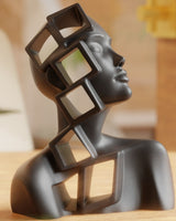 Abstract female bust sculpture with open geometric frames intersecting the figure, white finish