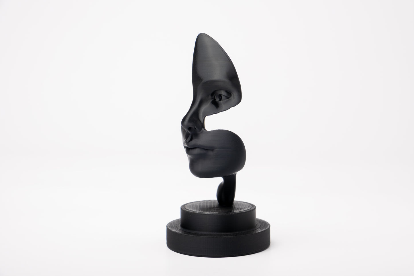 Note of Emotion abstract black sculpture styled on a minimalist shelf with books and a candle