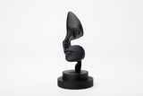 Note of Emotion abstract black sculpture styled on a minimalist shelf with books and a candle