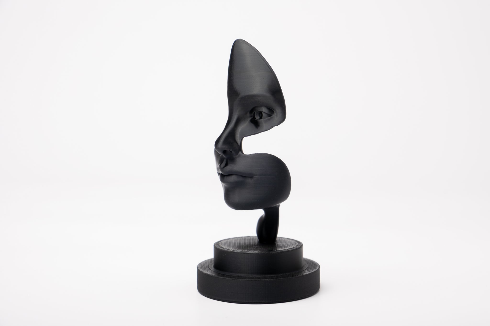 Note of Emotion abstract black sculpture styled on a minimalist shelf with books and a candle