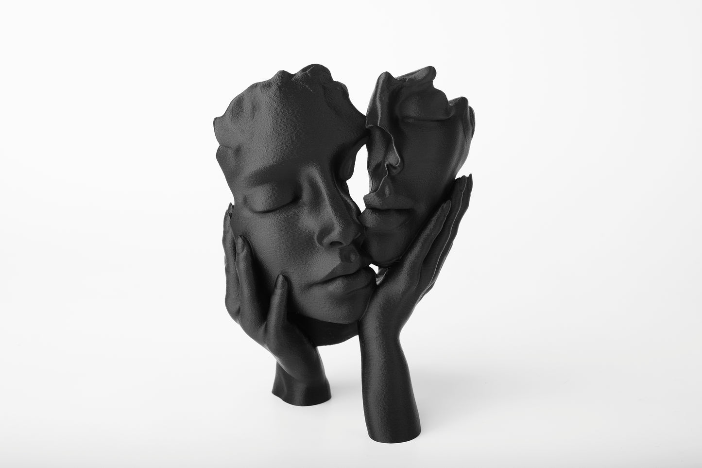 Ethereal Embrace abstract face sculpture styled on a dark wood shelf with soft ambient lighting