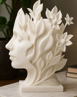 Close-up of a botanical bust sculpture showing a woman's face merging into leaves and flowers