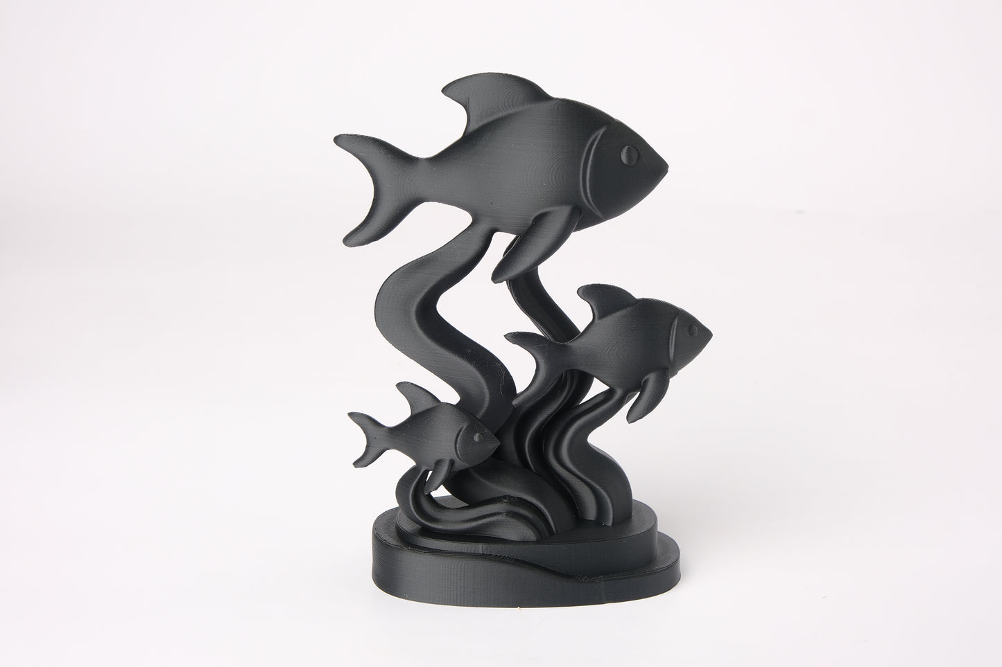 Fish sculpture styled on a wooden shelf alongside ceramics and a small plant