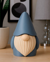 Close-up of a cosy gnome figurine with a large textured beard and rounded hat on a wooden desk
