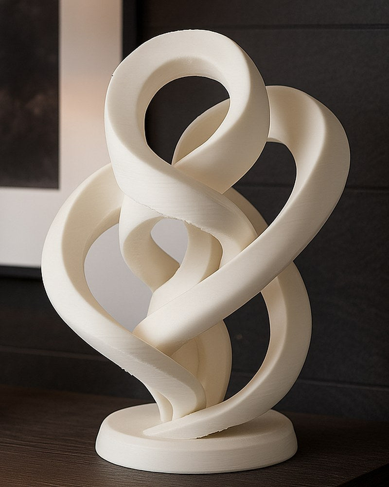 Abstract infinity twist sculpture in white, close-up showing smooth continuous loop form
