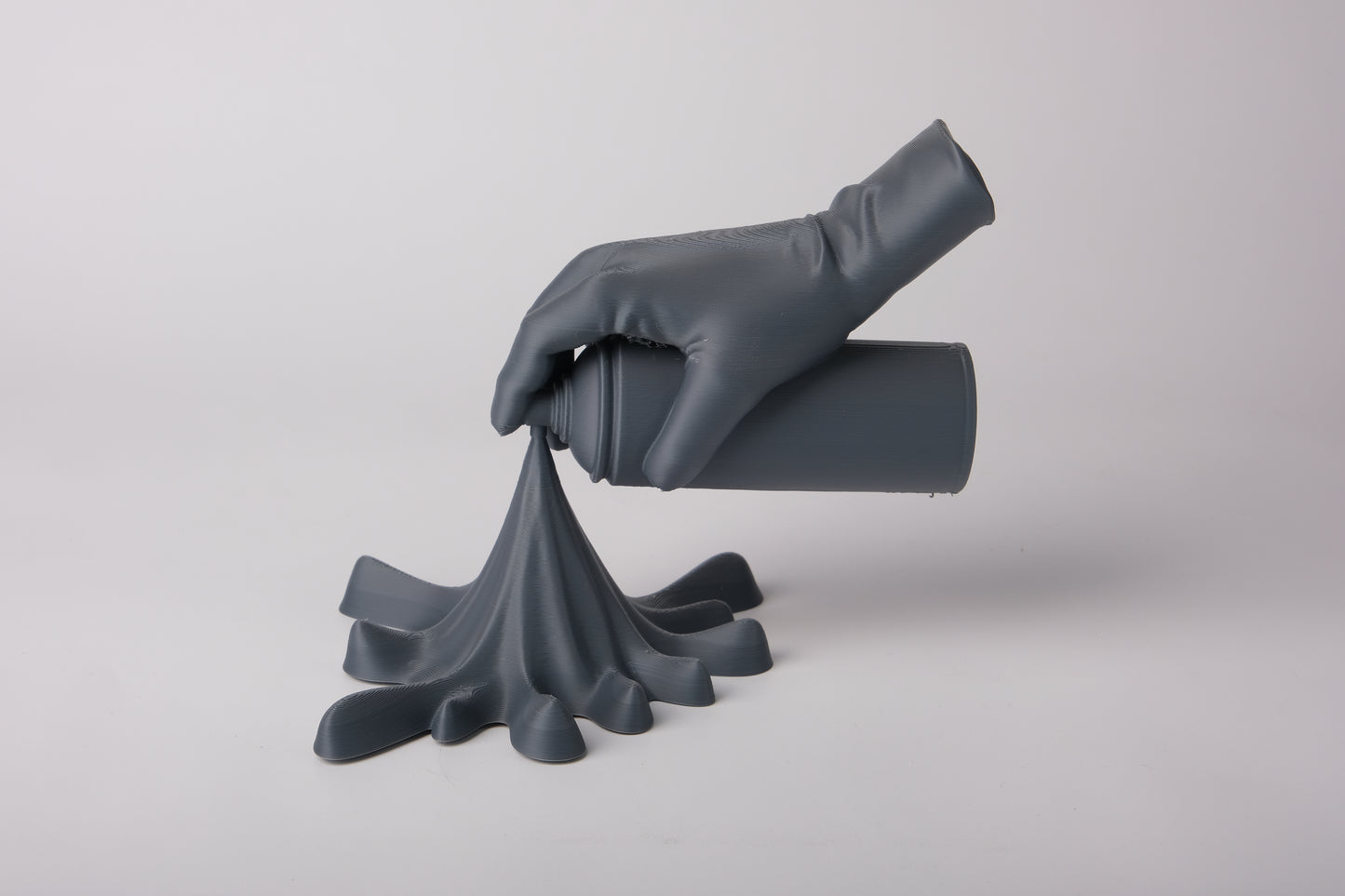 Spray paint hand sculpture styled on a concrete shelf in a modern urban interior