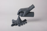 Spray paint hand sculpture styled on a concrete shelf in a modern urban interior