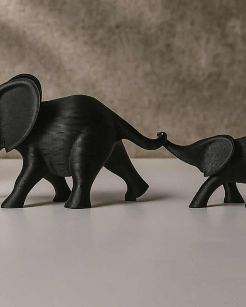 Minimalist elephant figurine set — two abstract elephants with trunks linked, matte finish, white background