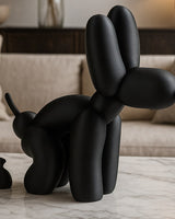 Balloon dog poop sculpture in white, shot close-up against a light background