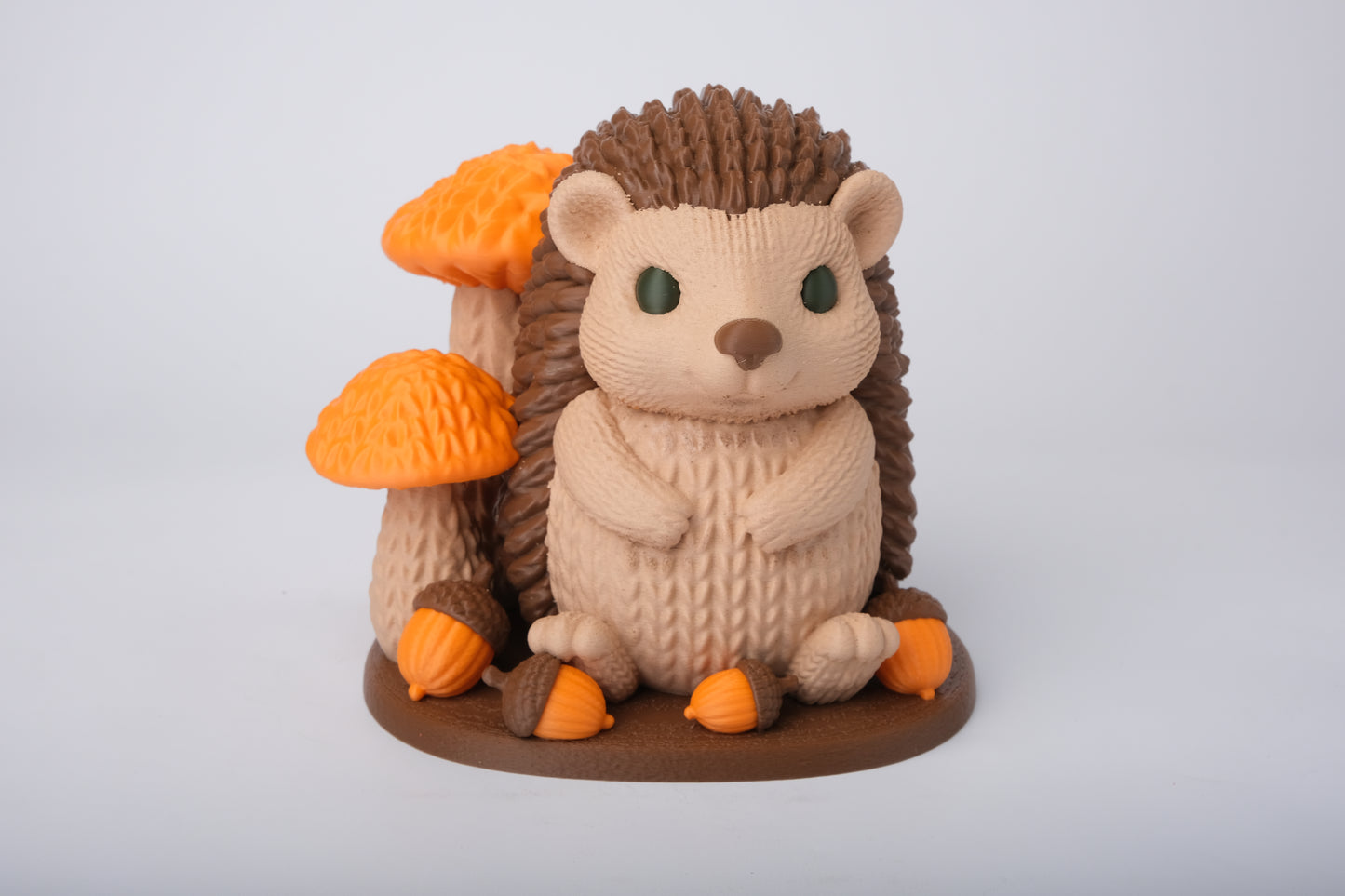 Hedgehog figurine styled on a wooden shelf with autumn leaves, candles and dried botanicals