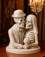 Skeleton bride and groom figurine standing together, groom in bowler hat, bride holding bouquet, white background