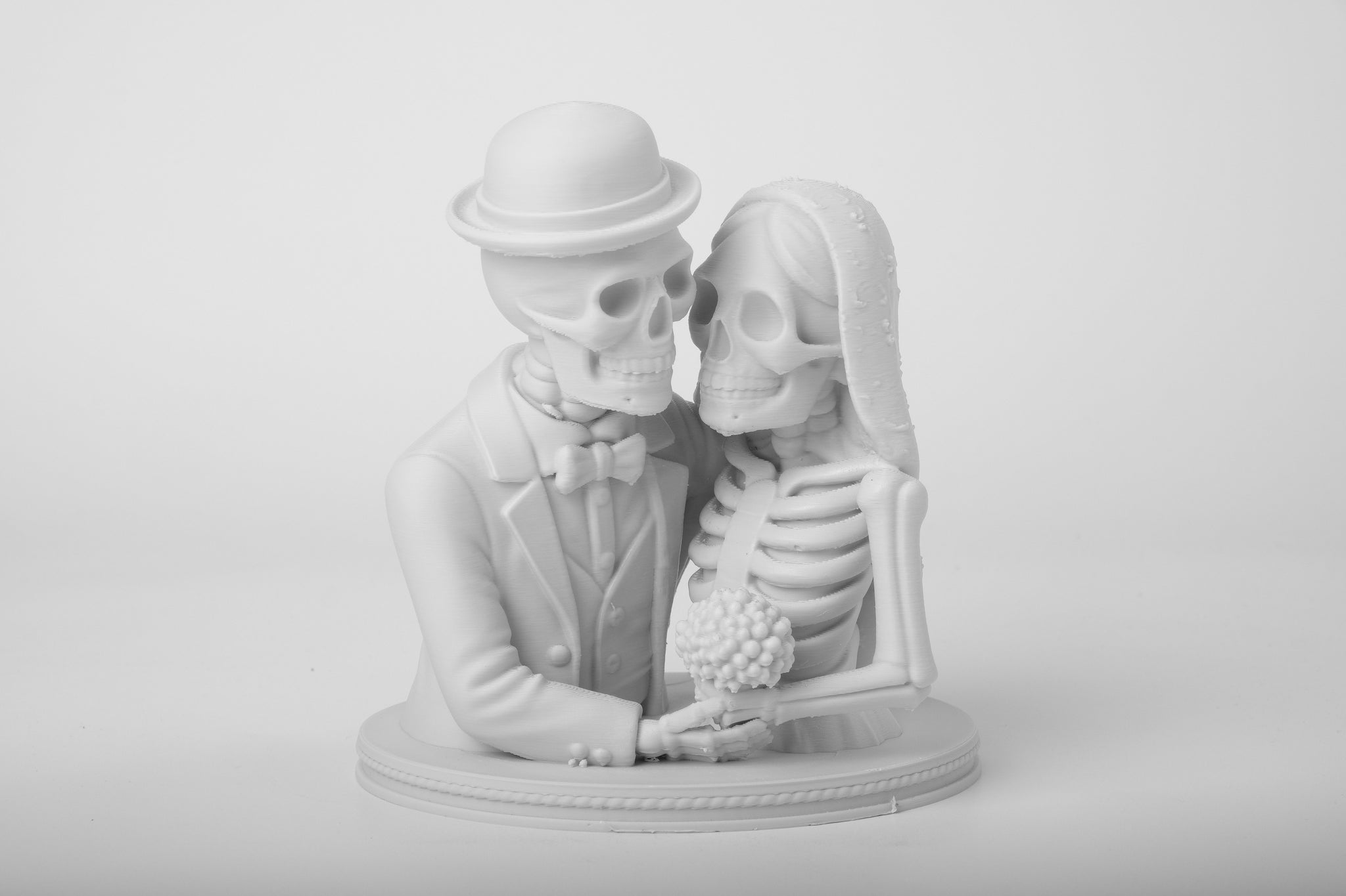 Gothic skeleton wedding figurine styled on a dark wooden shelf alongside candles and moody decor