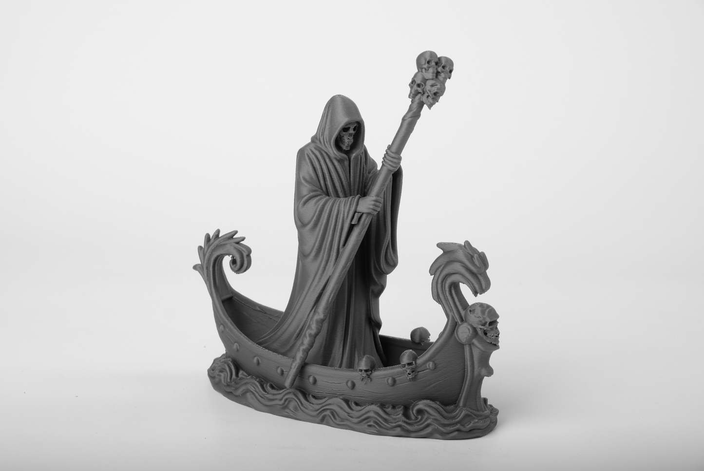 Death Arrived gothic statue styled on a dark wooden shelf with candlelight and moody decor