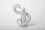 Dragon guardian fantasy sculpture styled on a minimalist dark wood shelf