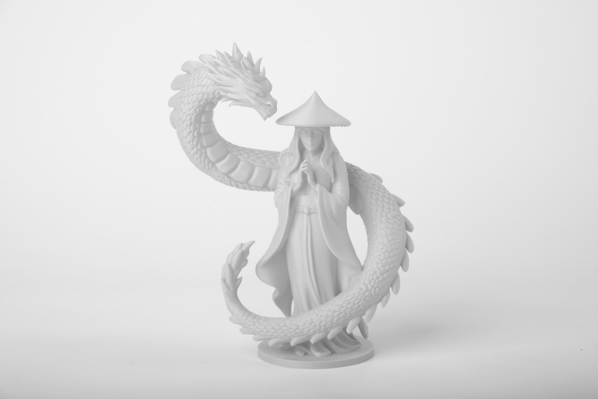 Dragon guardian fantasy sculpture styled on a minimalist dark wood shelf