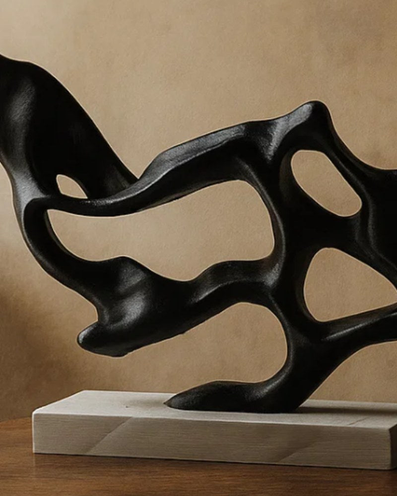 Close-up of Flow Structure abstract sculpture in matte black with organic curved lines and negative space