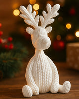 White knitted reindeer figurine on a wooden surface, matte finish with detailed knit texture