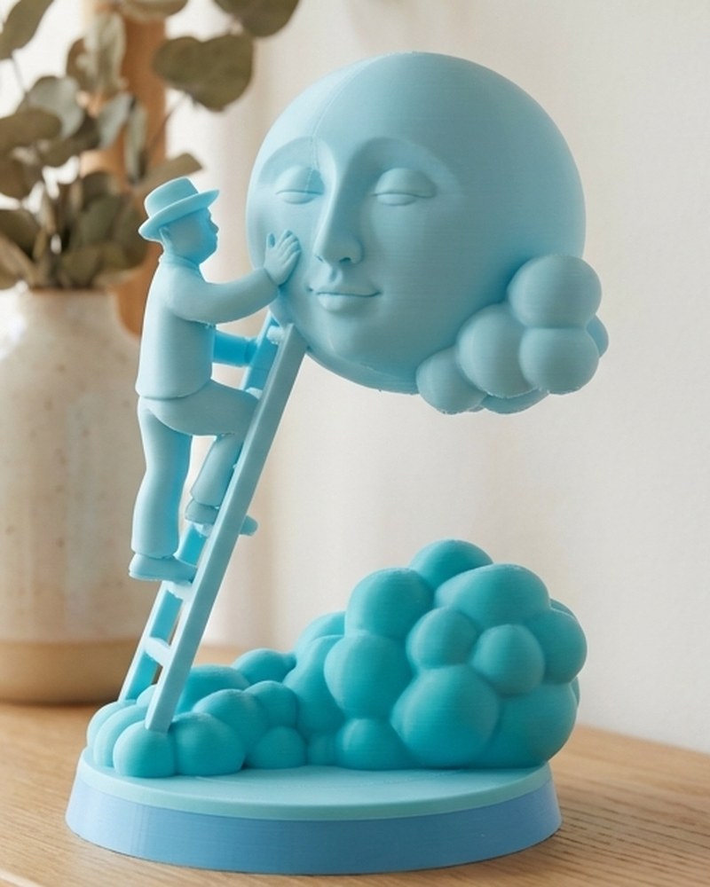 Close-up of a monochrome moon sculpture showing a small figure on a ladder touching the moon's face