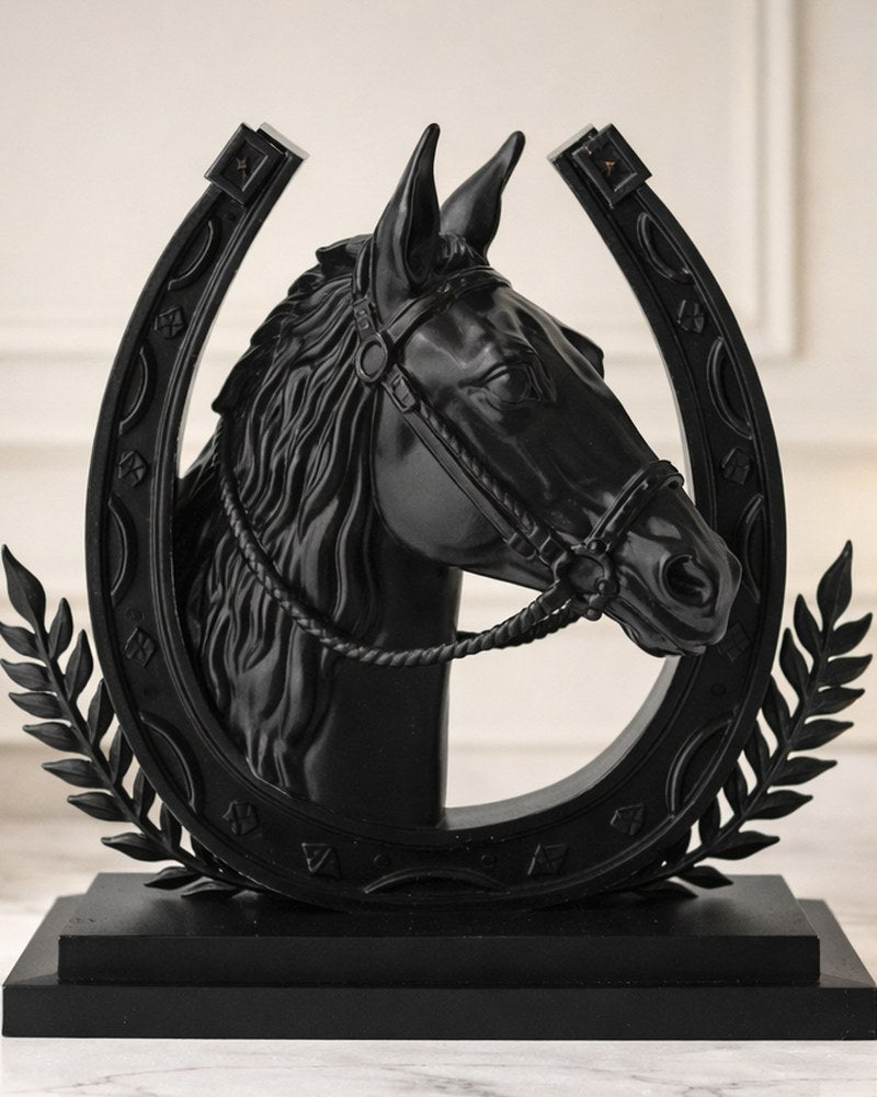 Matte black horse sculpture with horseshoe frame, front view on white background