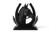 Horse sculpture styled on a wooden shelf with natural decor objects and soft light