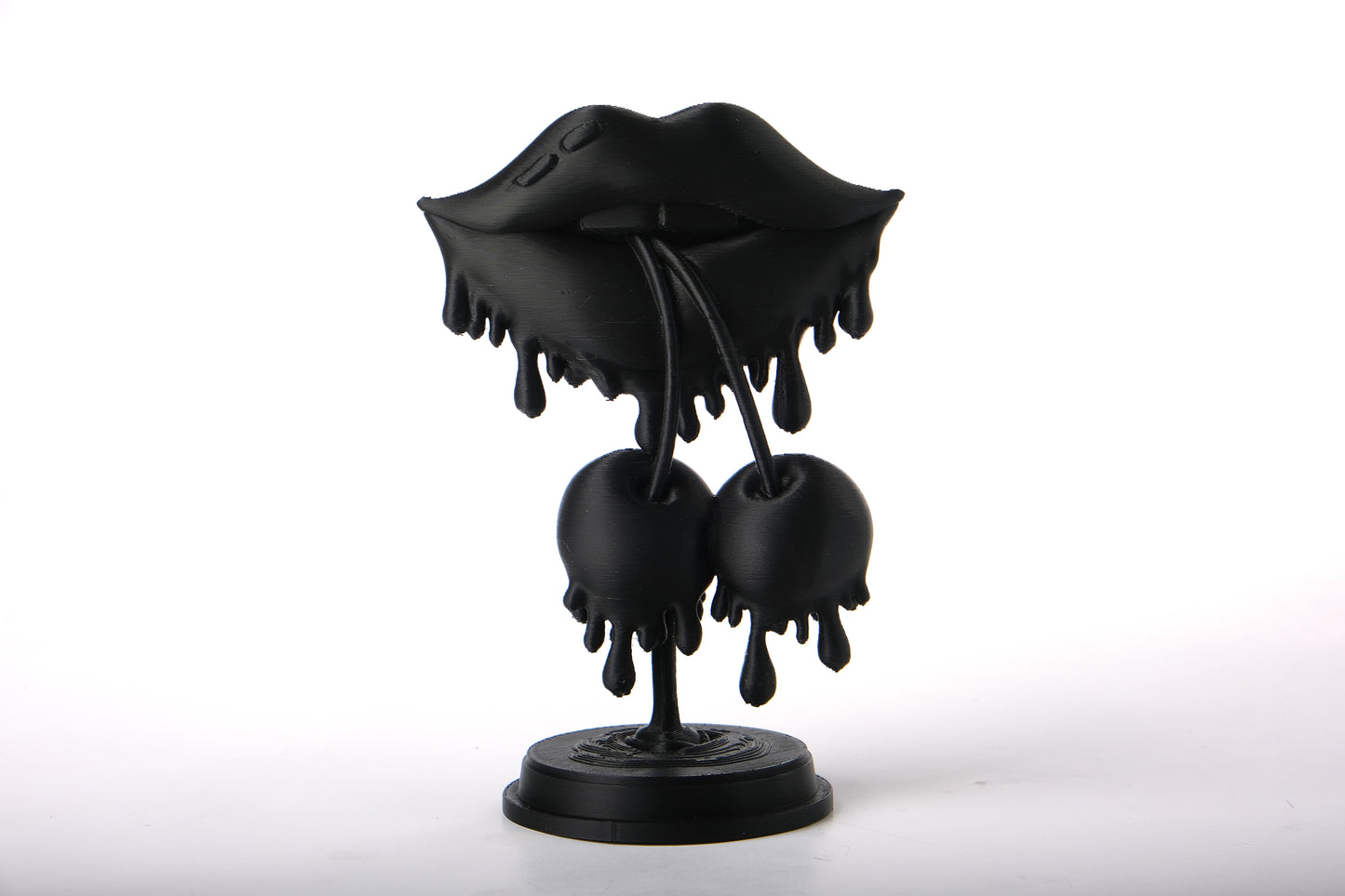 Bold lips sculpture styled on a wooden shelf alongside books and small plants