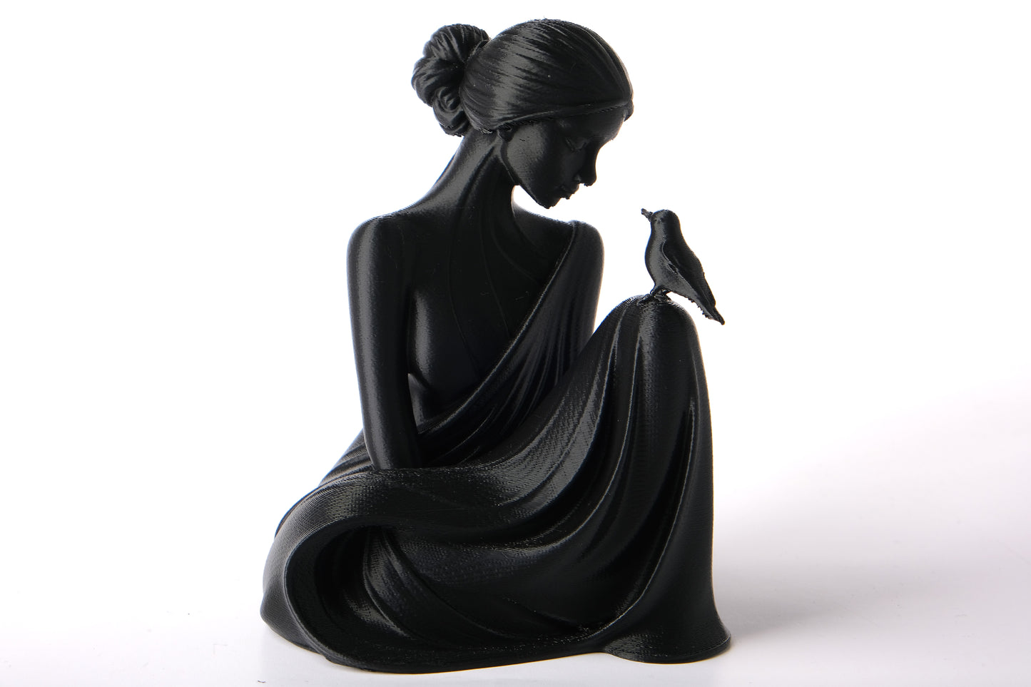 Bird Whisperer lady sculpture styled on a wooden shelf with dried botanicals