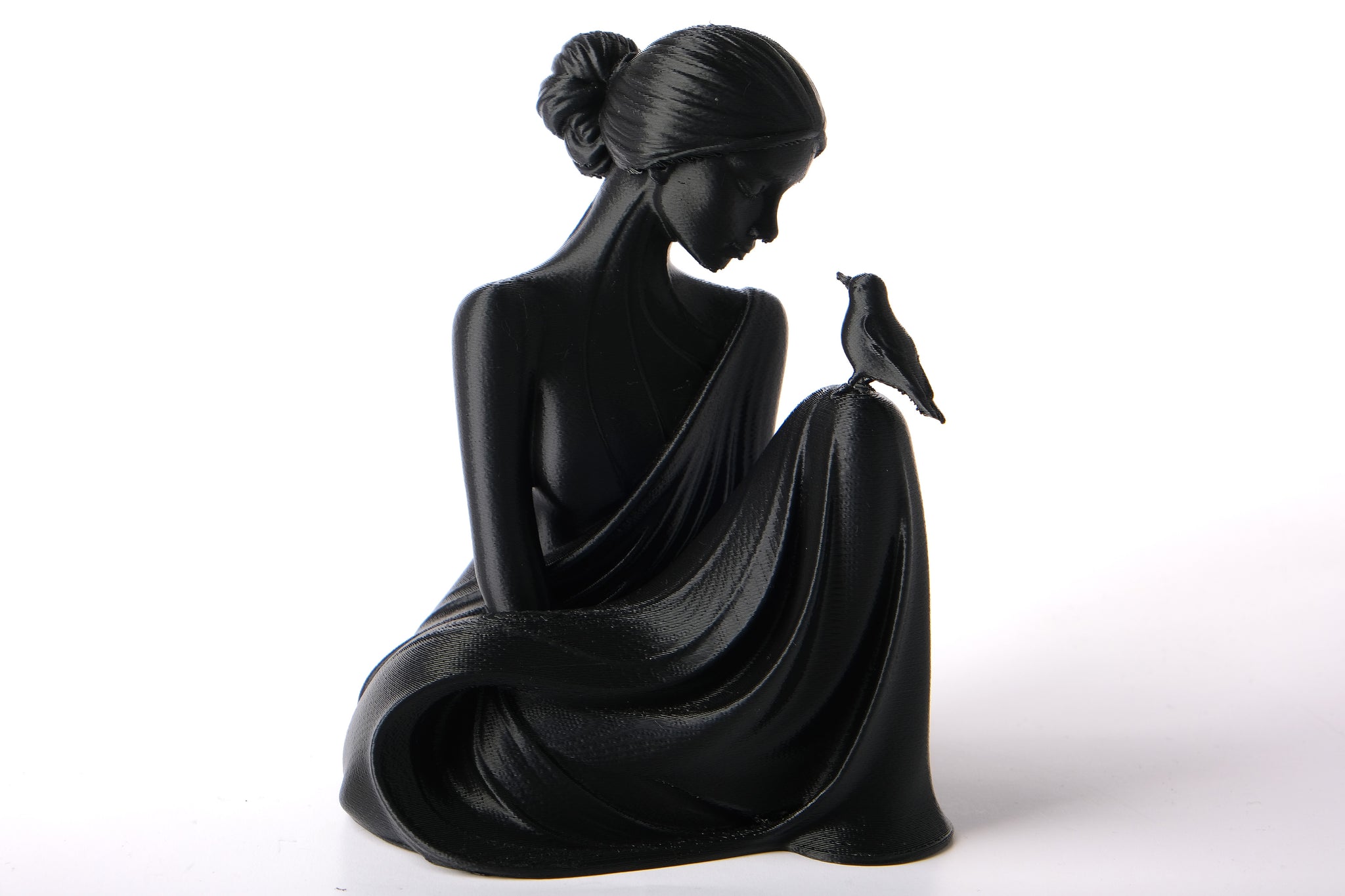 Bird Whisperer lady sculpture styled on a wooden shelf with dried botanicals