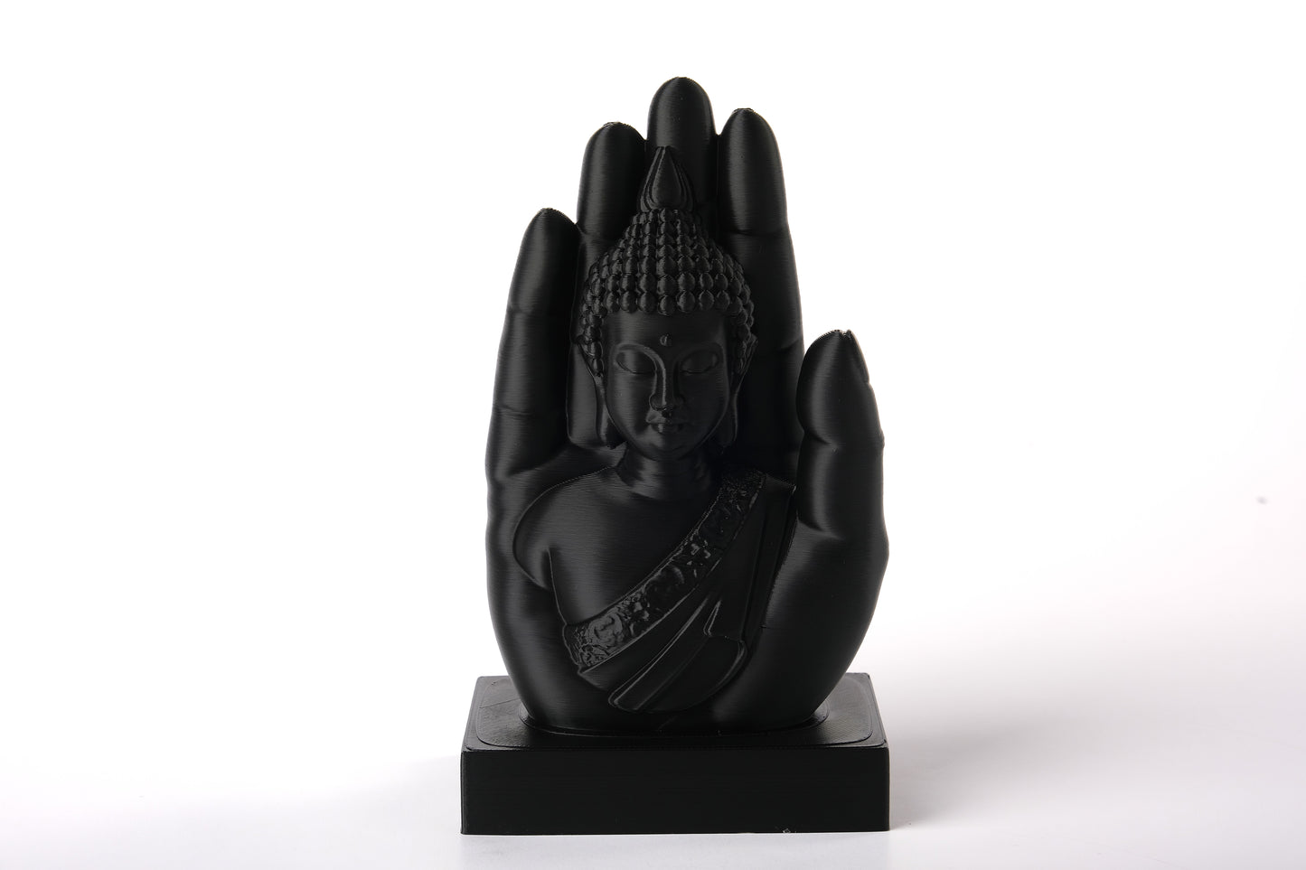 Buddha hand sculpture styled on a wooden shelf beside candles and dried botanicals in a calm meditation corner