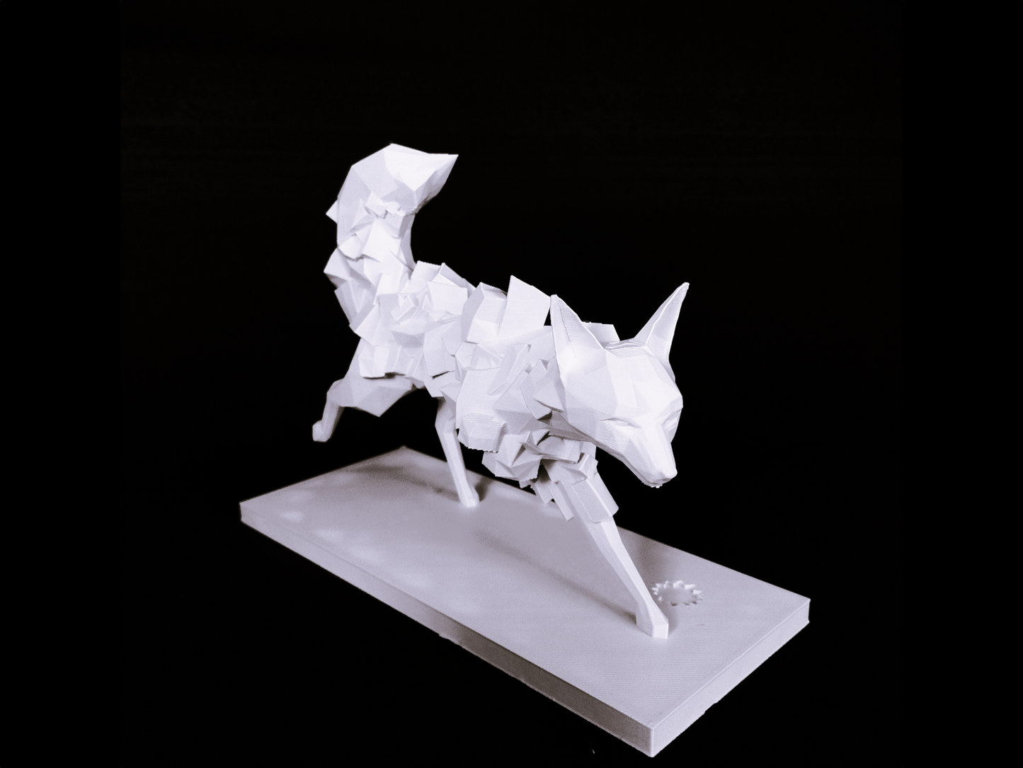 Geometric fox sculpture styled on a wooden shelf beside a ceramic vase and dried grasses