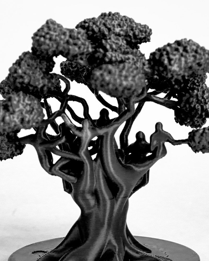 Close-up of a tree sculpture with intertwining roots and spreading branches against a light background
