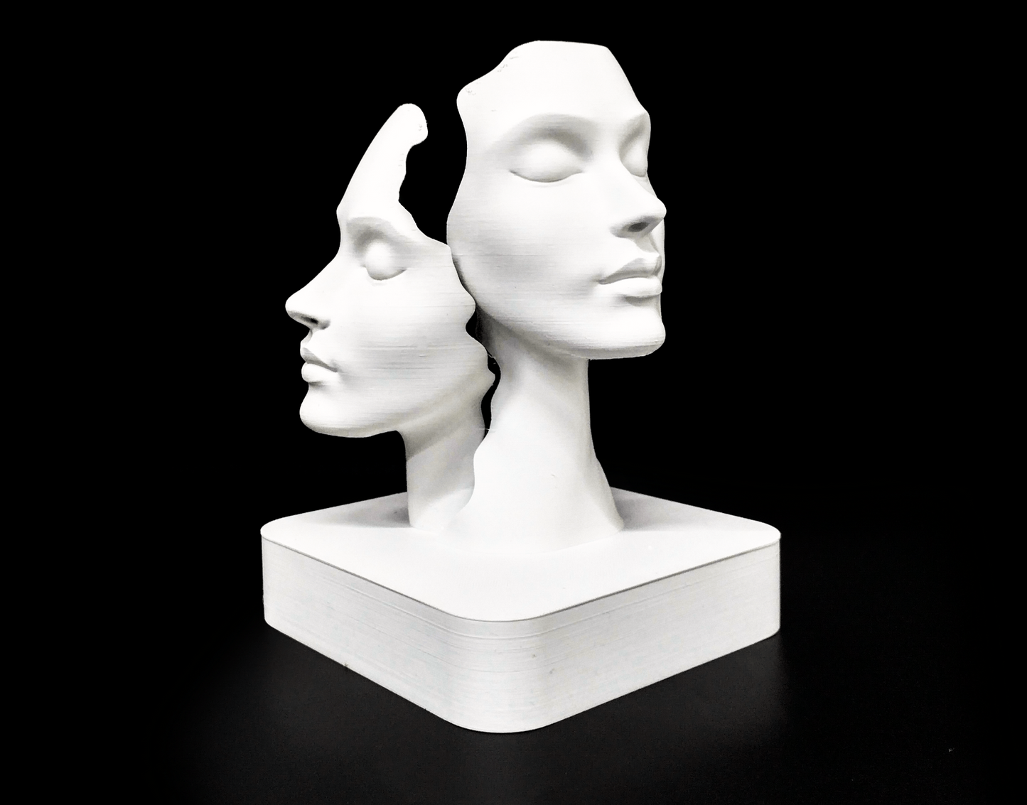 Duality faces sculpture styled on a wooden shelf in a Scandinavian living room interior