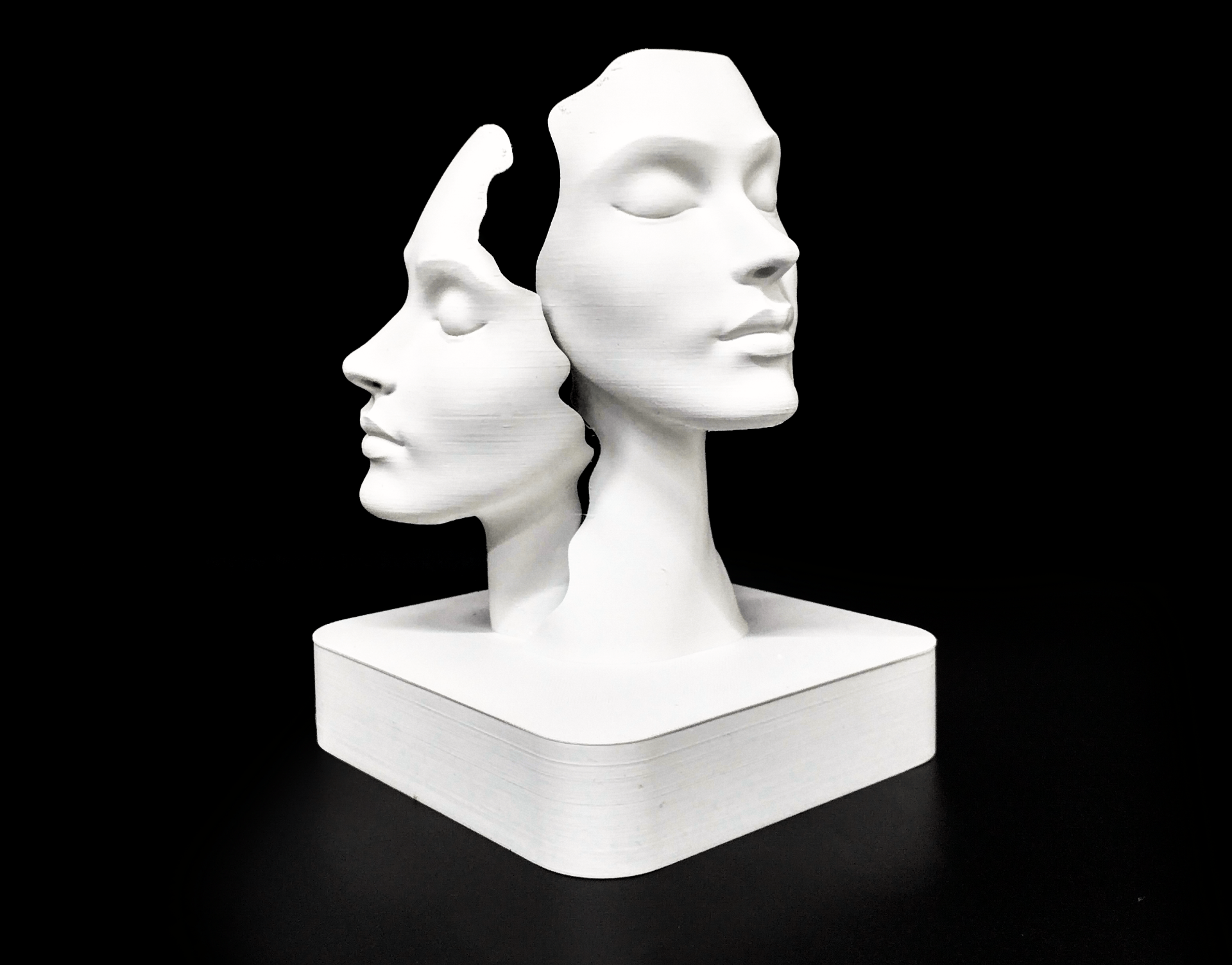 Duality faces sculpture styled on a wooden shelf in a Scandinavian living room interior