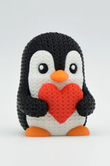 Close-up of a knitted valentine penguin with textured surface and small heart detail, 49 DKK
