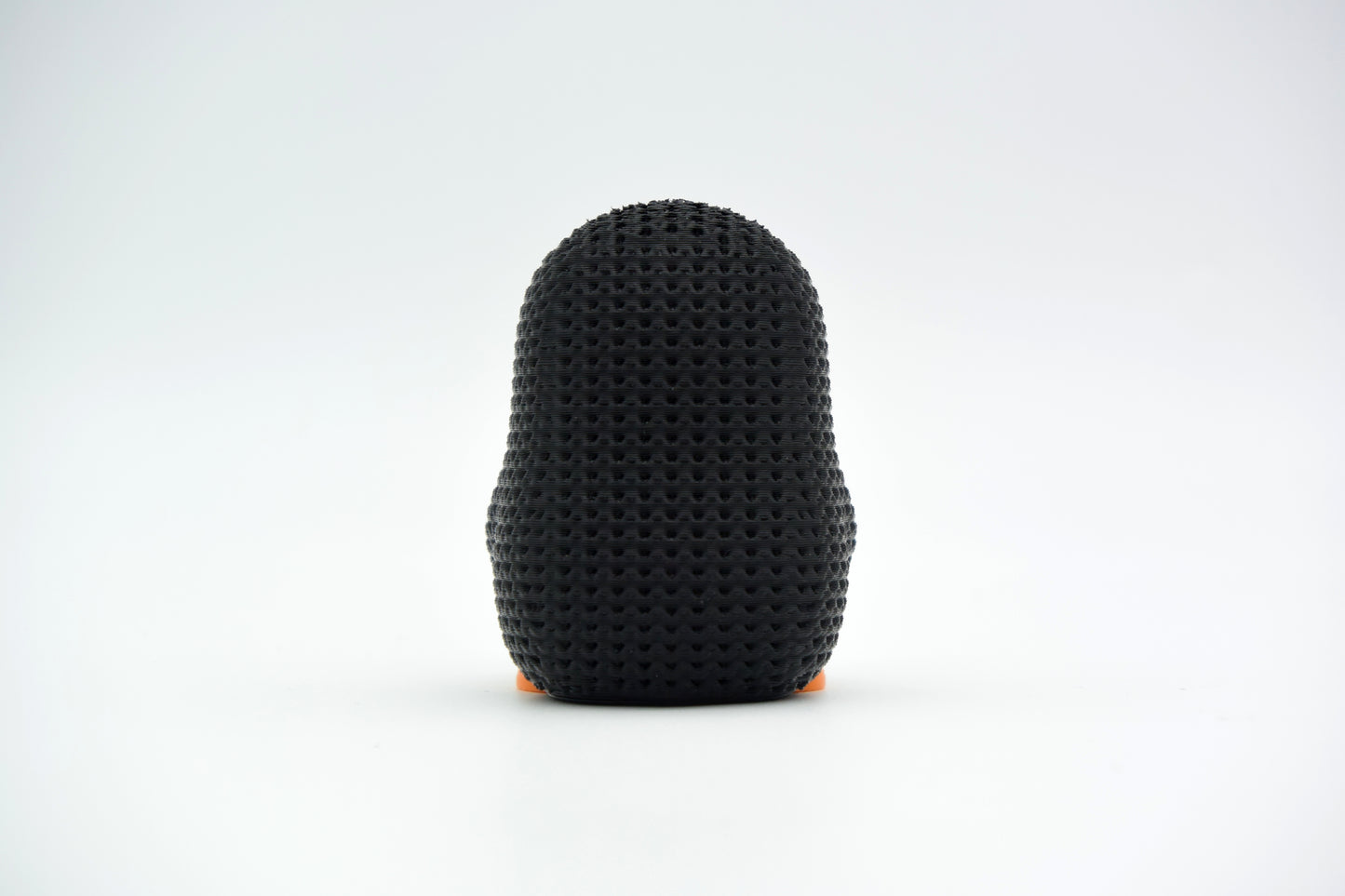 Detail shot of the knit-like texture on the surface of a small decorative penguin figure