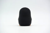 Detail shot of the knit-like texture on the surface of a small decorative penguin figure