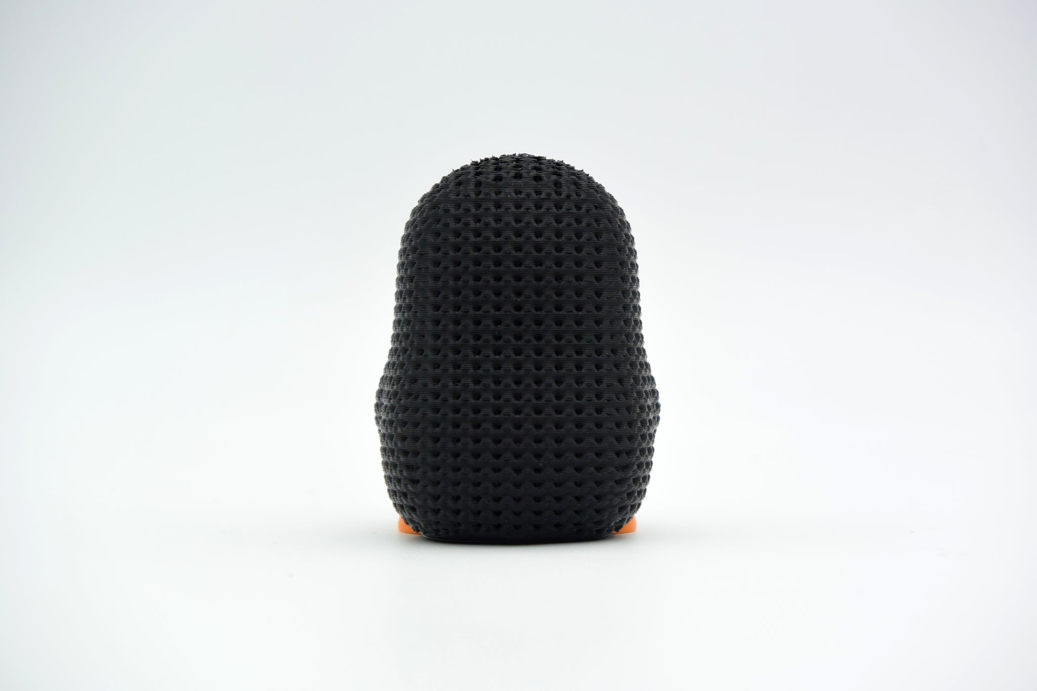 Detail shot of the knit-like texture on the surface of a small decorative penguin figure